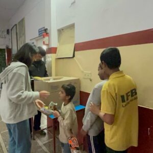 BS_Riaa giving stuff to a blind boy