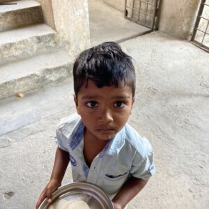 small boy with idli plate